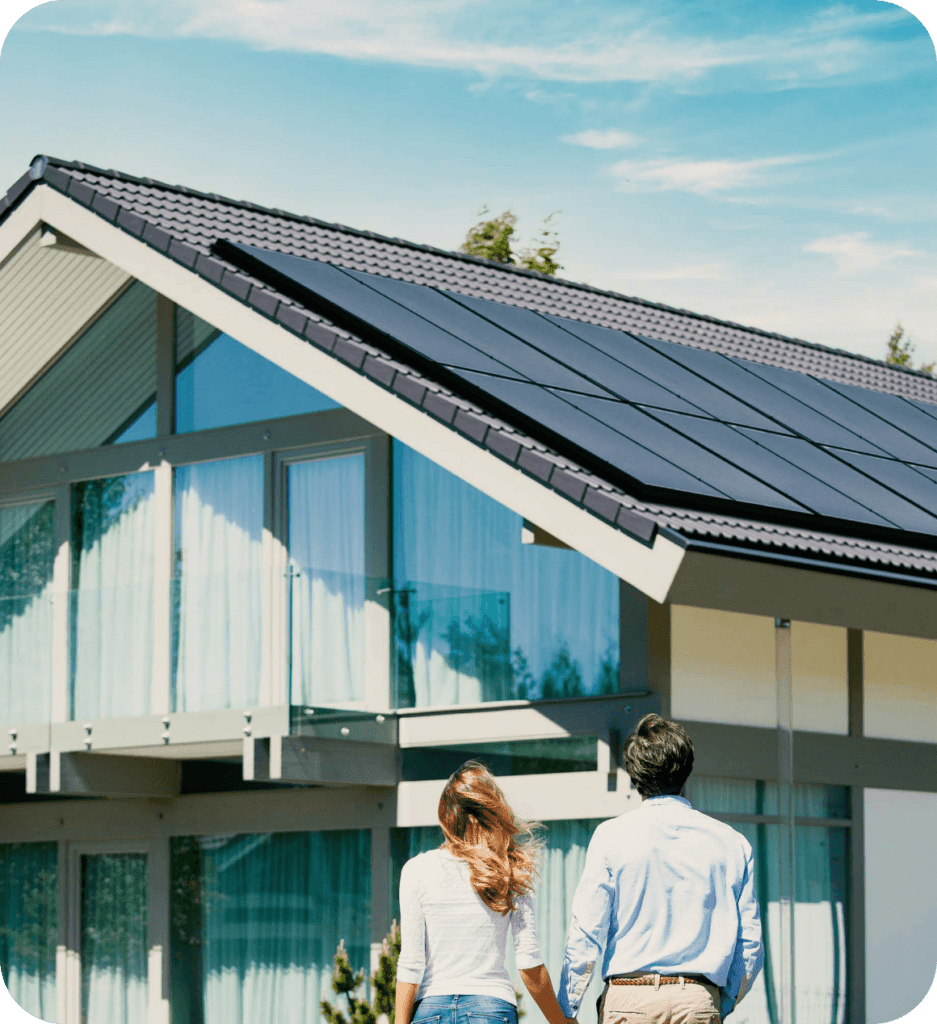 Couple looking at a house with solar panels