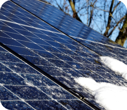 Side view of snow on top of solar panels
