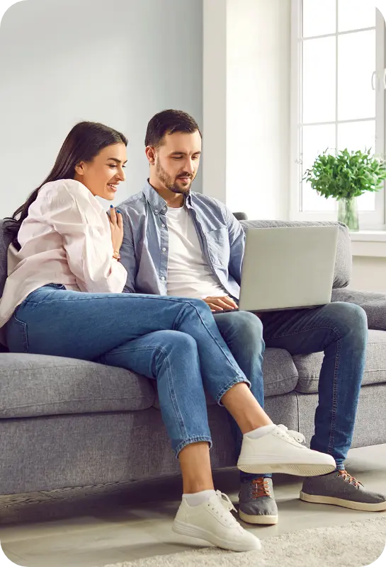 Man and woman on computer looking at home solar financing