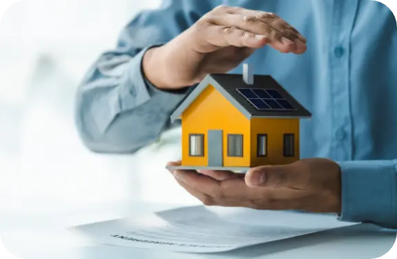 Man holding tiny home in his hands