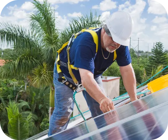 Worker in harness installing panels